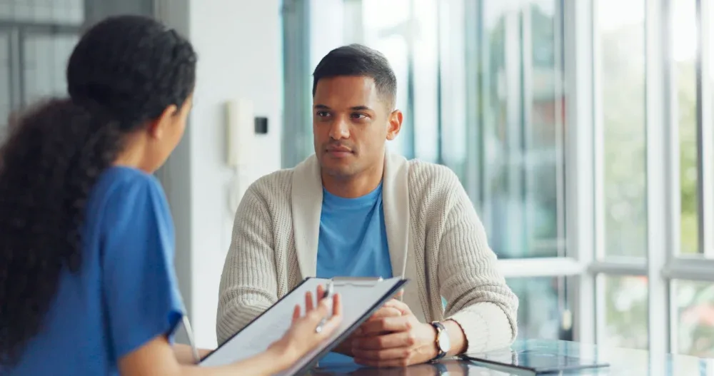 therapist guiding man in opioid treatment Jacksonville, FL